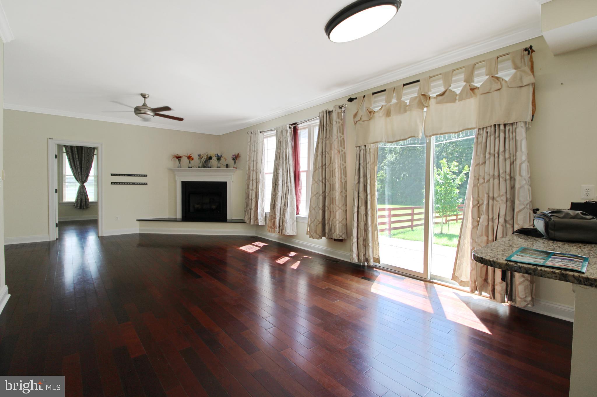 113 Paulowina Road Queen Anne, MD 21657 - Photo 7 of 42 a view of an empty room with wooden floor and a window