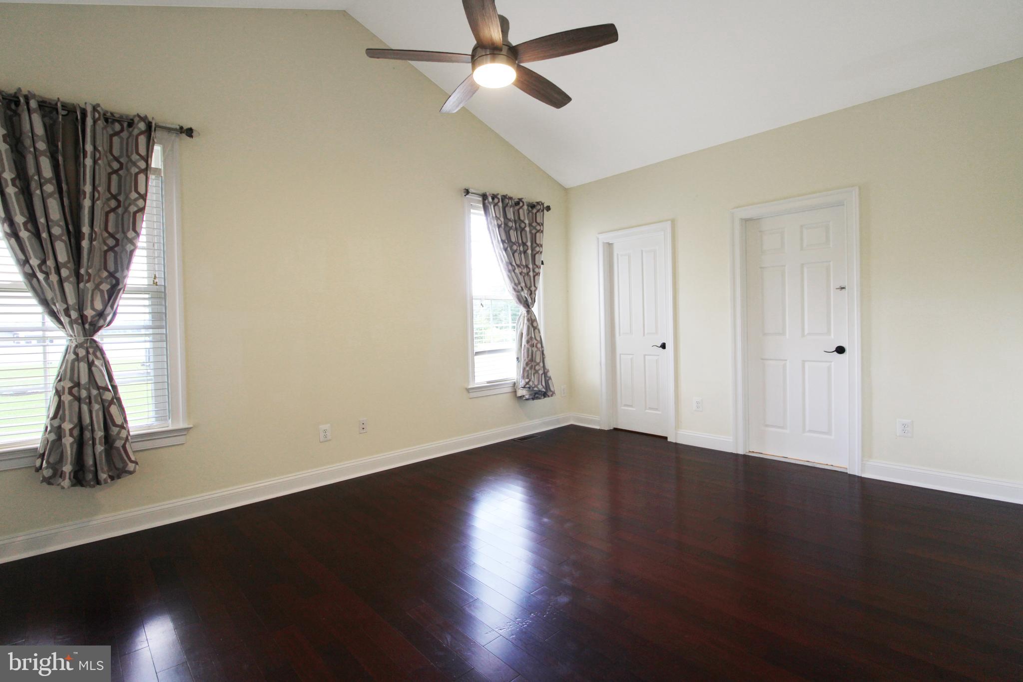113 Paulowina Road Queen Anne, MD 21657 - Photo 8 of 42 a view of an empty room with wooden floor and a window