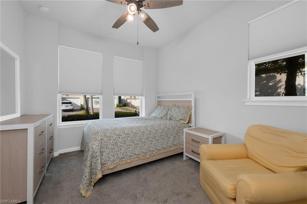 4631 Arboretum Circle, Unit 101 Naples, FL 34112 - Photo 11 of 36 a bedroom with a bed and cabinets