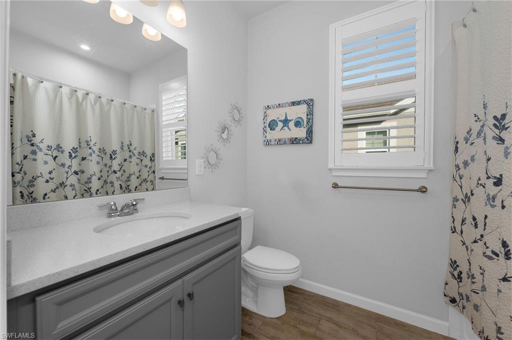 4631 Arboretum Circle, Unit 101 Naples, FL 34112 - Photo 12 of 36 a bathroom with a sink toilet and shower