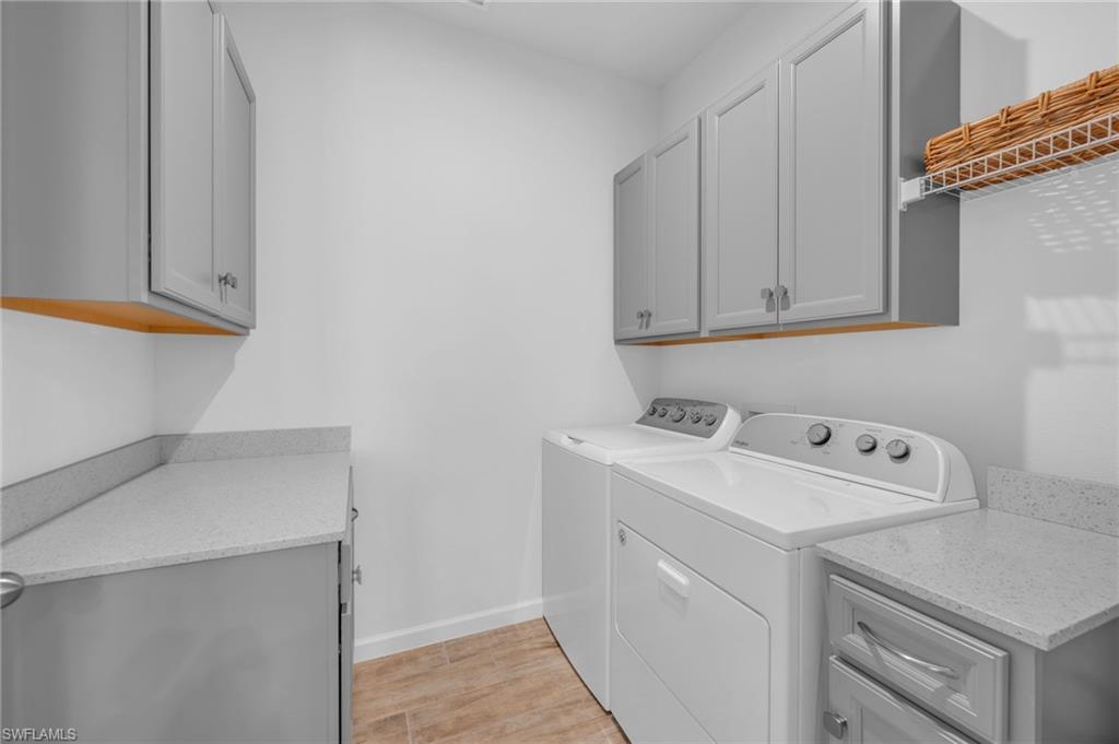 4631 Arboretum Circle, Unit 101 Naples, FL 34112 - Photo 15 of 36 a utility room with dryer and washer