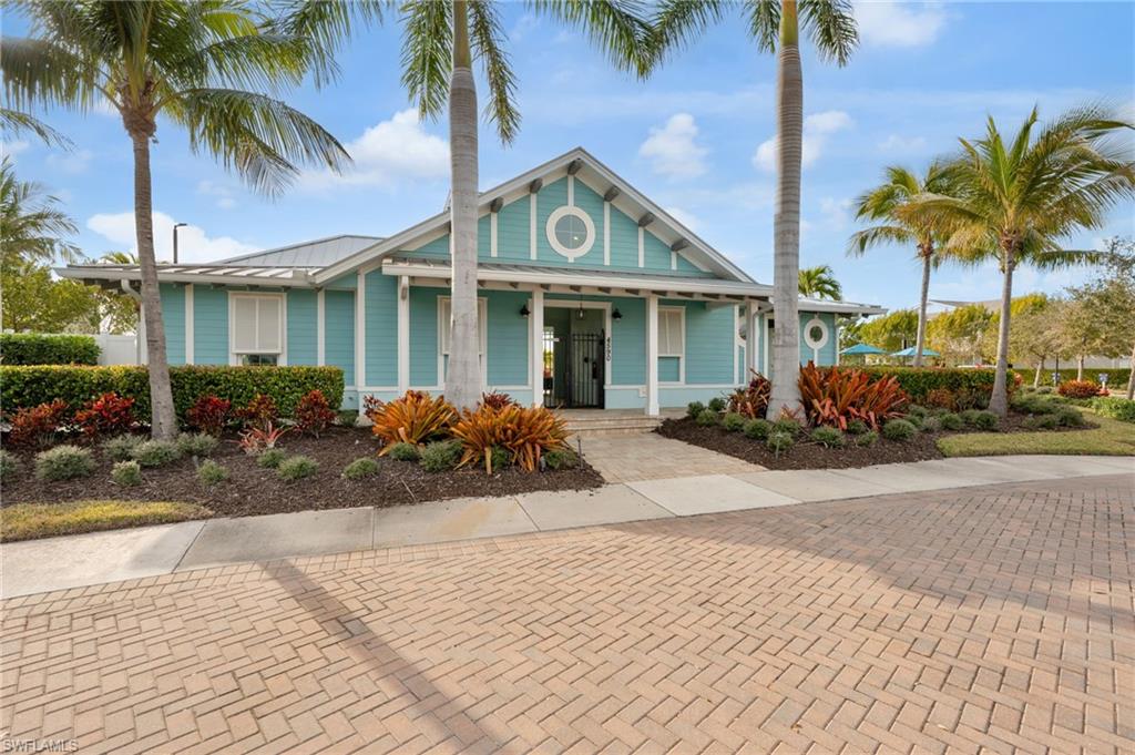 4631 Arboretum Circle, Unit 101 Naples, FL 34112 - Photo 20 of 36 a front view of a house with garden
