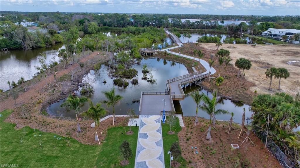 4631 Arboretum Circle, Unit 101 Naples, FL 34112 - Photo 27 of 36 an aerial view of a house with a yard and lake view