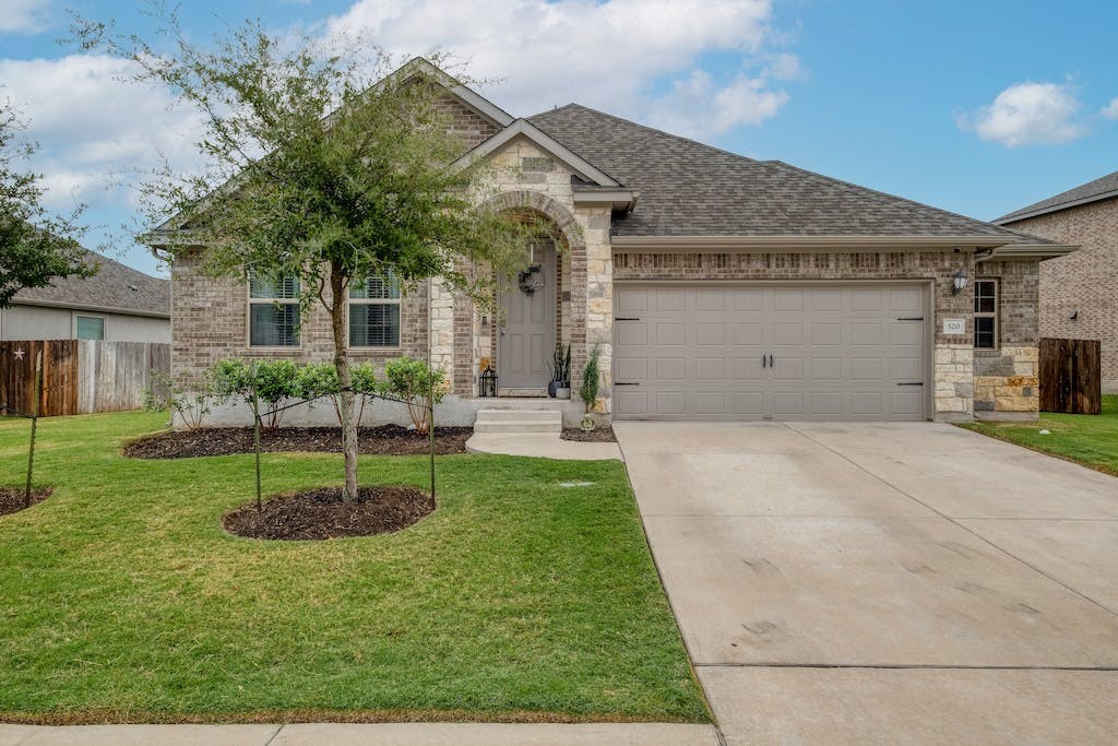 520 Middle Brook Drive Leander, TX 78641 - Photo 1 of 1 a front view of a house with a yard and garage