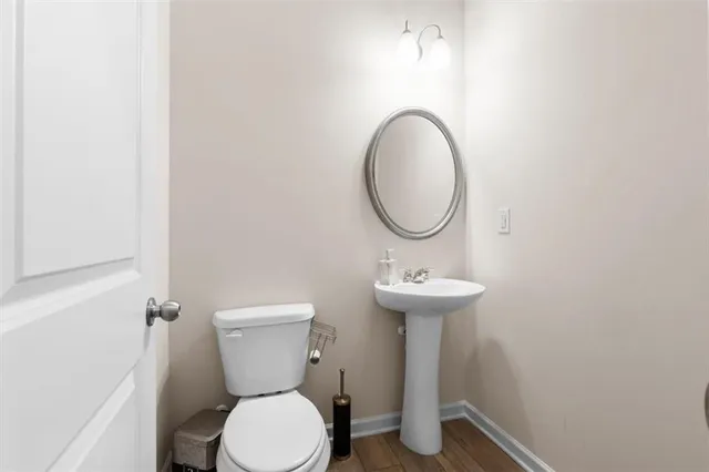 a bathroom with a toilet sink and mirror