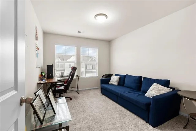 a living room with furniture and a piano
