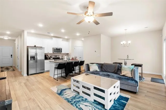 a living room with furniture and kitchen view