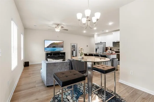 a living room with kitchen island furniture and a flat screen tv