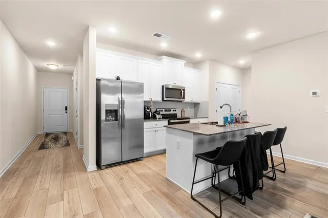 a kitchen with a sink appliances and a refrigerator