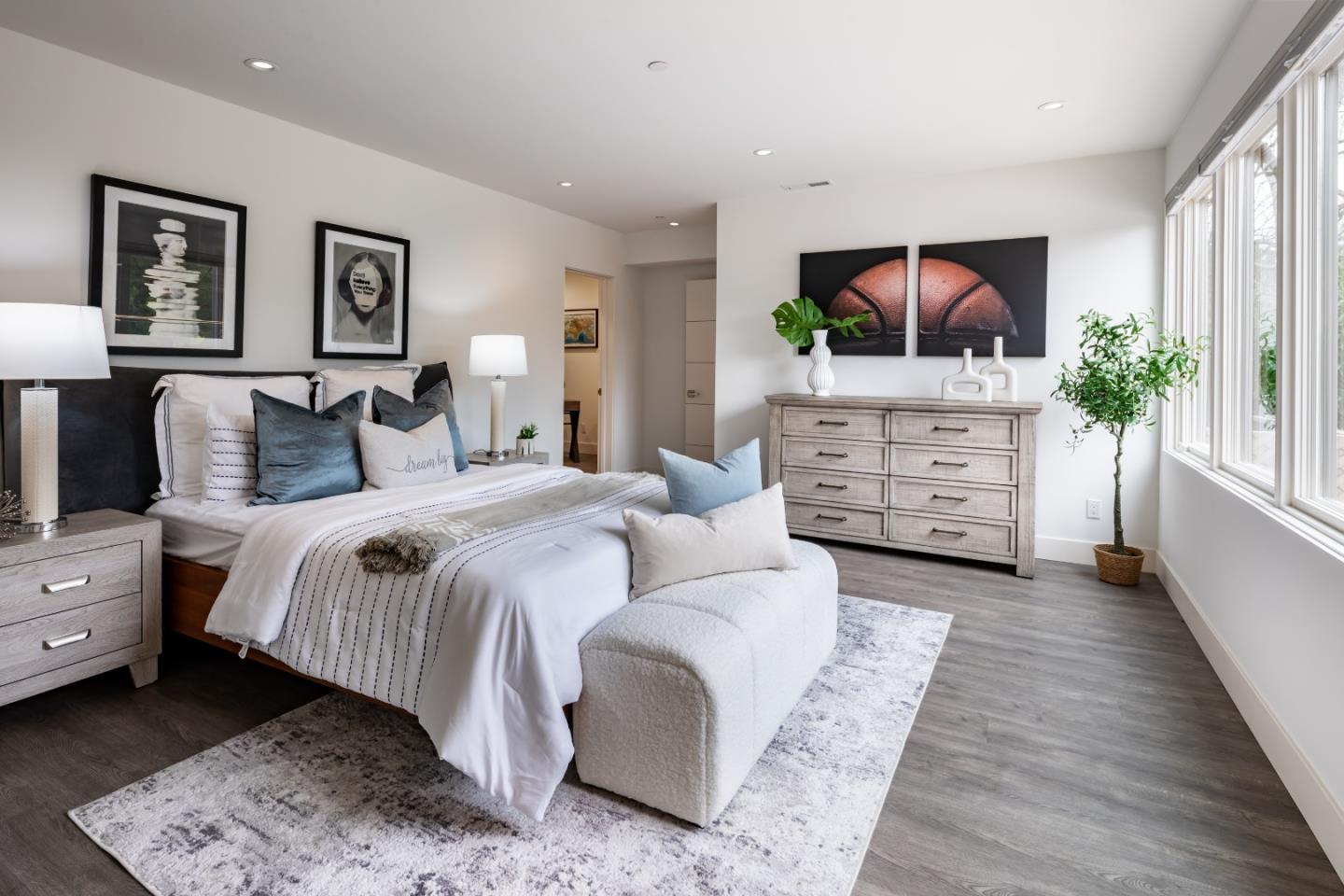 1045 Trinity Drive Menlo Park, CA 94025 - Photo 19 of 31 a spacious bedroom with a bed and a flat screen tv