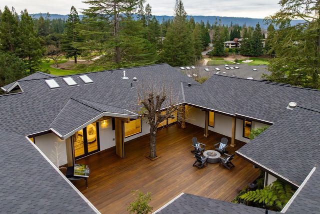 a view of a patio with table and chairs a barbeque