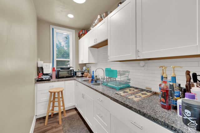 1632 South Main Street Springville, UT 84663 - Photo 6 of 93 Kitchen with white cabinetry, decorative backsplash, light wood-style floors, light stone counters, and recessed lighting