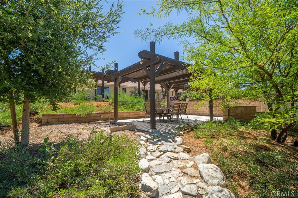 16639 Fox Glen Road Riverside, CA 92504 - Photo 117 of 153 a view of a patio with table and chairs under an umbrella