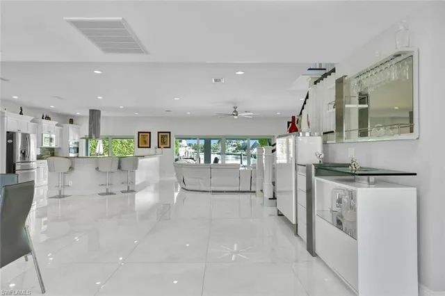 a kitchen with stainless steel appliances kitchen island granite countertop a stove and a white cabinets