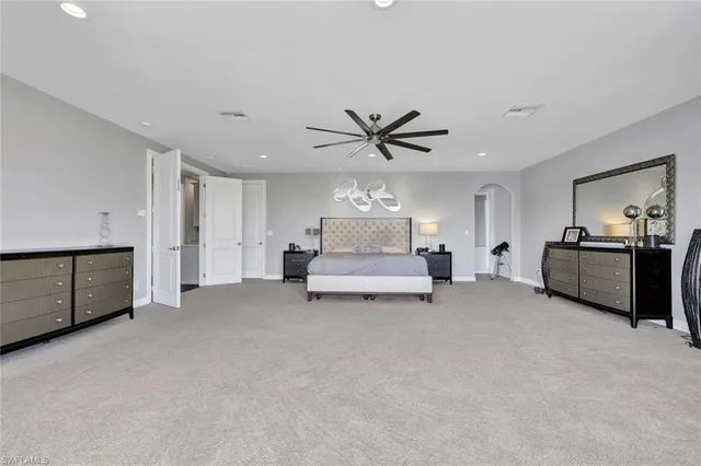 a living room with furniture and a ceiling fan