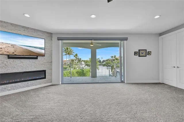 a view of an empty room with a fireplace and a window