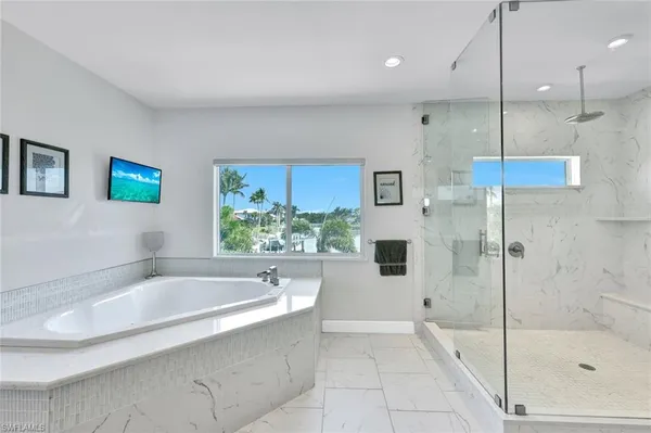 a bathroom with a bathtub and a shower