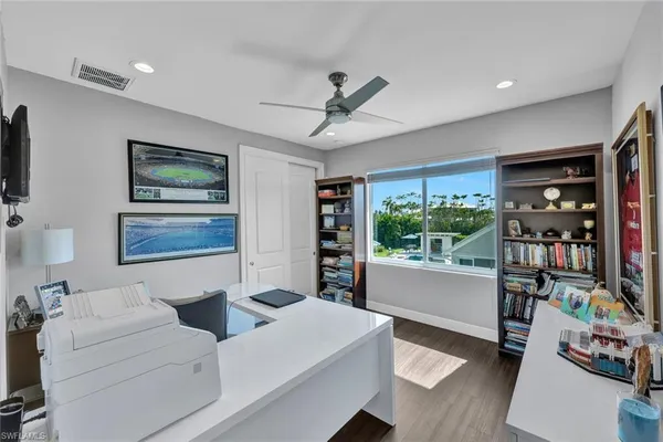 a living room with furniture and a bookshelf