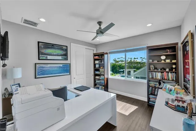 a living room with furniture and a bookshelf