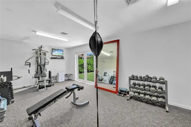 a room with gym equipment and a large window