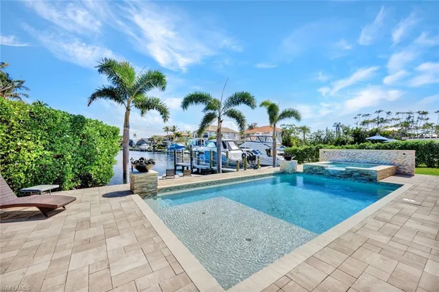a view of swimming pool with outdoor seating and plants