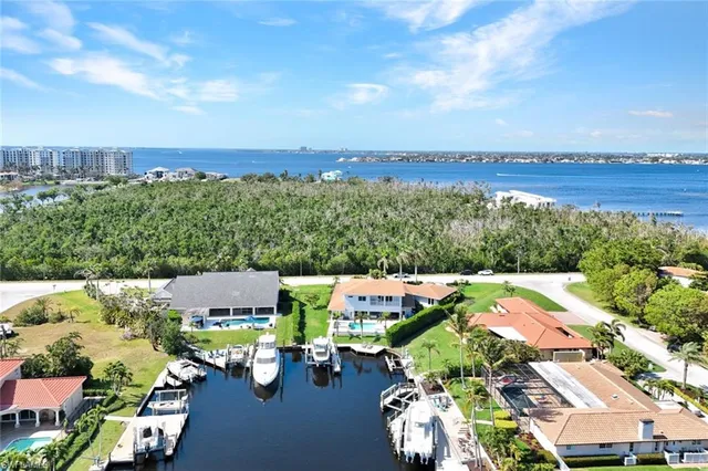 an aerial view of a house with yard swimming pool and lake view