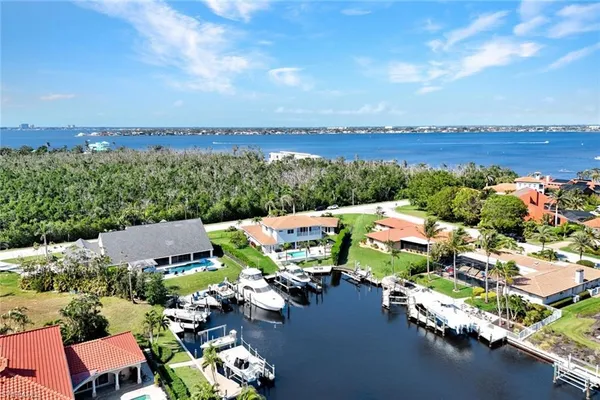an aerial view of a house with a garden and lake view