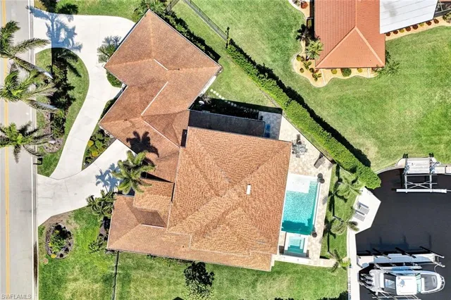 an aerial view of a house with a yard