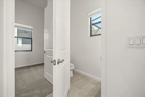a bathroom with a toilet and a shower