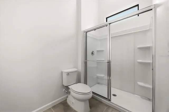 an empty room with a cabinet and mirrors