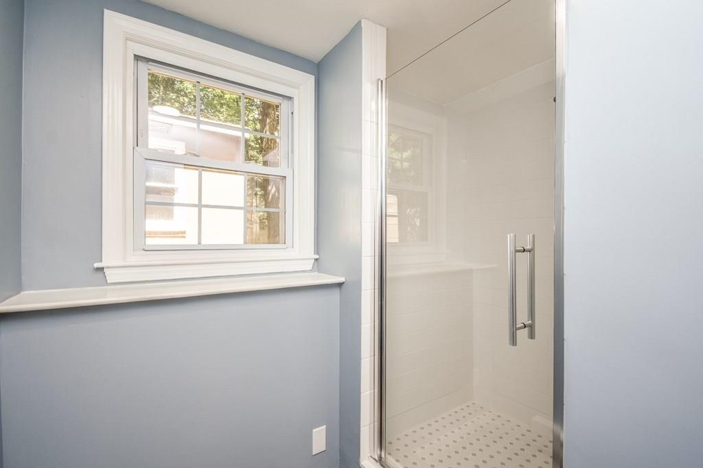131 New Estate Road Littleton, MA 01460 - Photo 14 of 16 a bathroom with a window and a shower