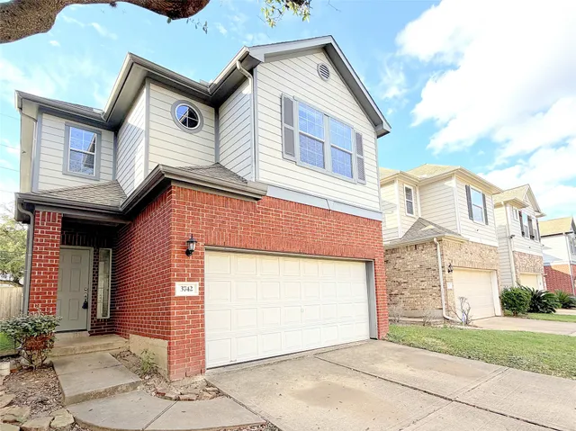 a front view of a house with a garage