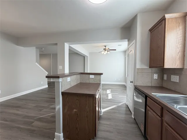 a kitchen with kitchen island a counter top space and cabinets