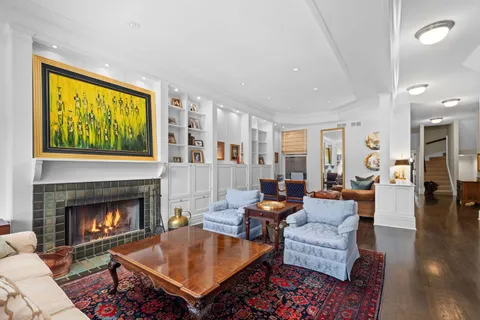 a living room with furniture a table and a fireplace