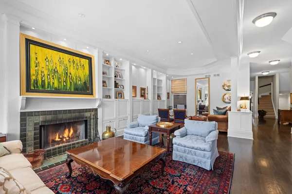 a living room with furniture a table and a fireplace