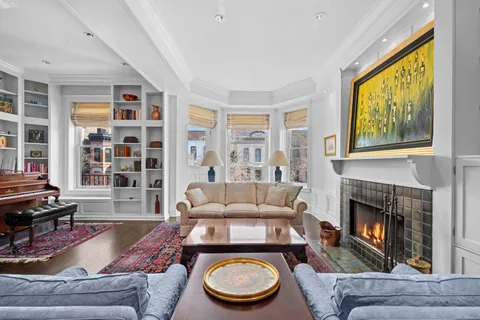 a room with furniture a rug and a window