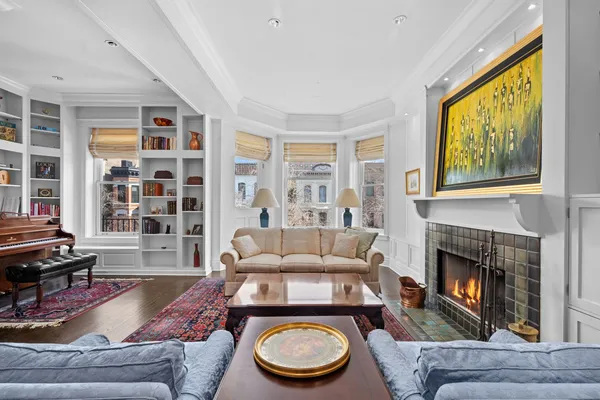 a room with furniture a rug and a window