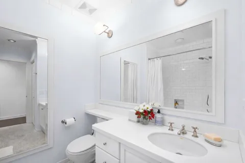 a bedroom with a bed and a potted plant