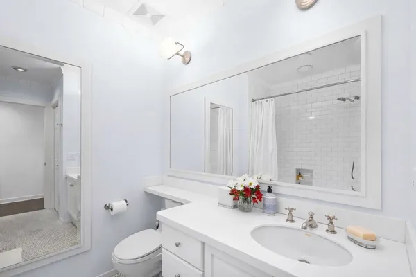 a bedroom with a bed and a potted plant