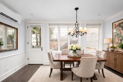 a view of a dining room with furniture wooden floor and chandelier