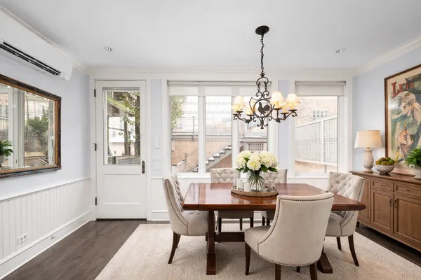a view of a dining room with furniture wooden floor and chandelier