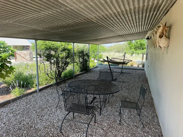 a view of patio with table and chairs and wooden floor