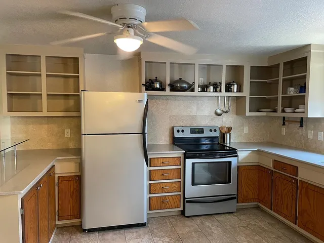 a kitchen with stainless steel appliances granite countertop a stove and a refrigerator