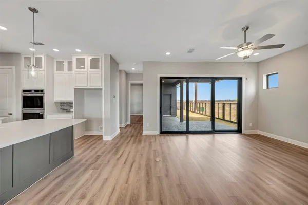 a kitchen with stainless steel appliances a sink a stove top oven a counter space and cabinets