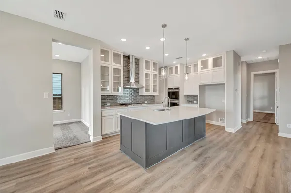 a view of kitchen and hall with wooden floor