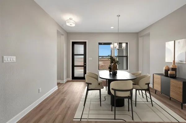 a view of a a dining room with furniture window and wooden floor