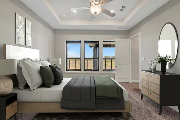 a bedroom with a large bed and a chandelier