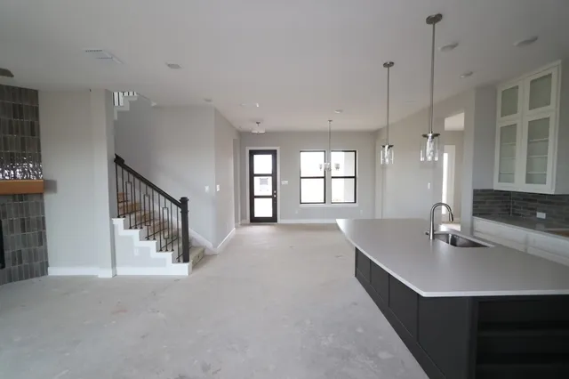 a kitchen with stainless steel appliances a sink and wooden cabinets