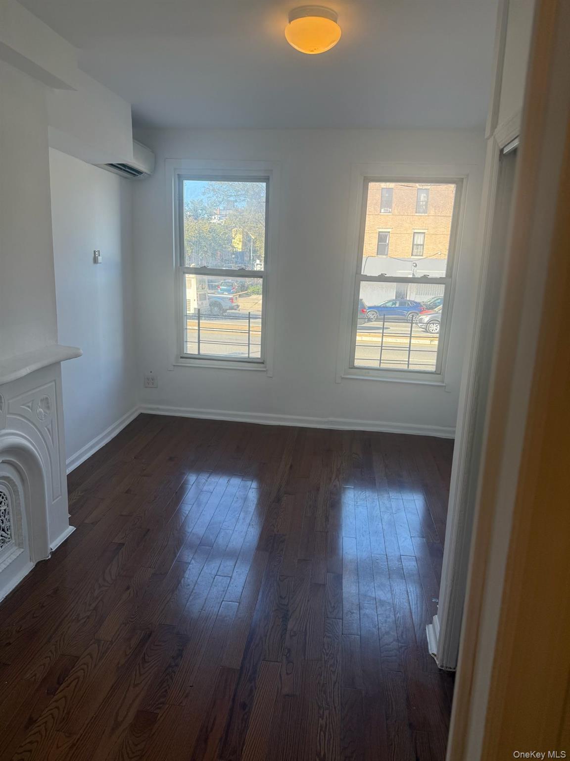 2280 Atlantic Avenue, Unit 1 Brooklyn, NY 11233 - Photo 2 of 5 a view of an empty room with wooden floor and a window