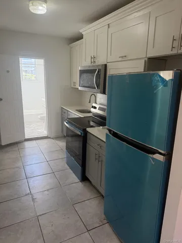 a kitchen with stainless steel appliances granite countertop a refrigerator and a stove